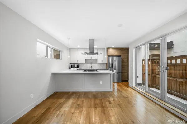a kitchen with stainless steel appliances a sink stove and refrigerator