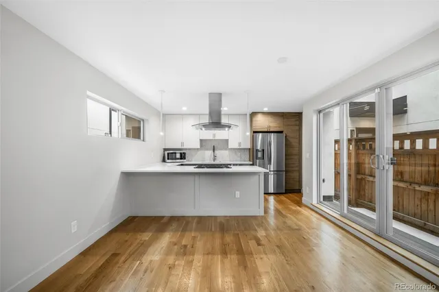 a kitchen with stainless steel appliances a sink stove and refrigerator