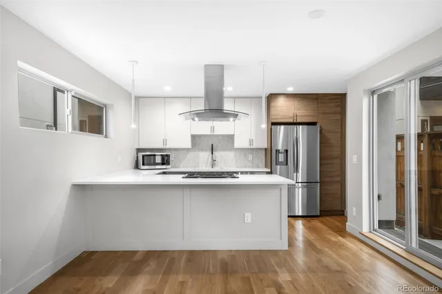 a kitchen with stainless steel appliances a refrigerator a sink and a stove