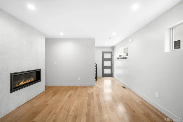 a view of empty room with a fireplace and a window