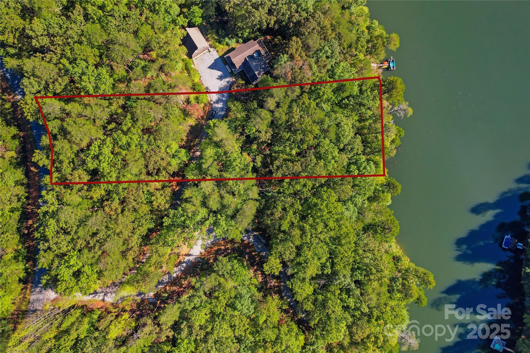 Lot 15 South Cove Rd Mill Spring, Unit 15 Mill Spring, NC 28756 - Photo 14 of 47 a backyard of a house with lots of green space and trees all around