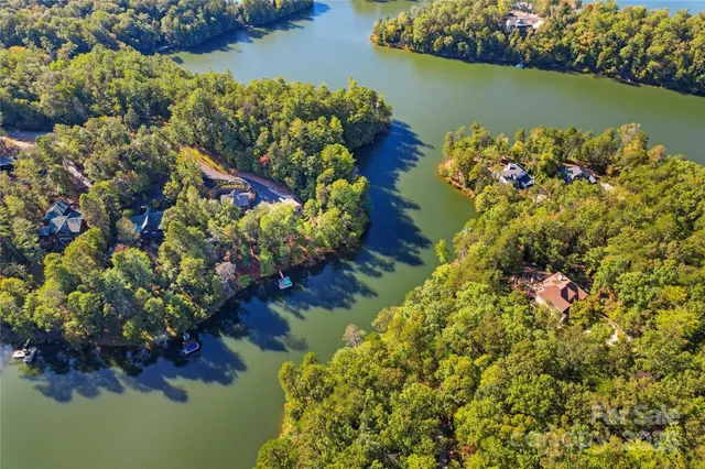 an aerial view of a houses with a lake view