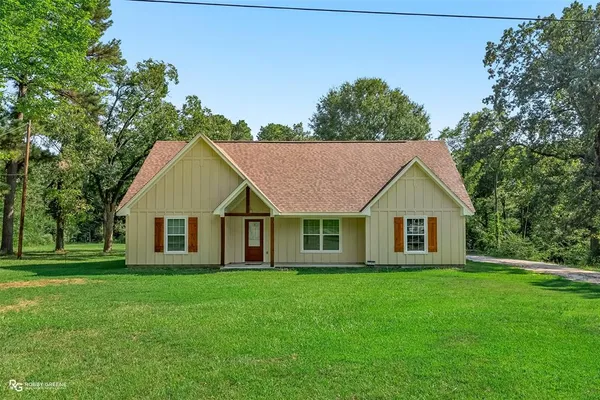 a house that is sitting in the grass