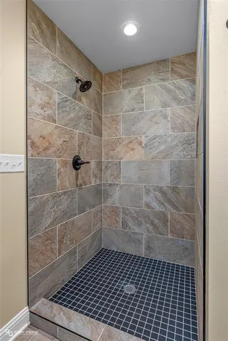 a bathroom with a glass door shower