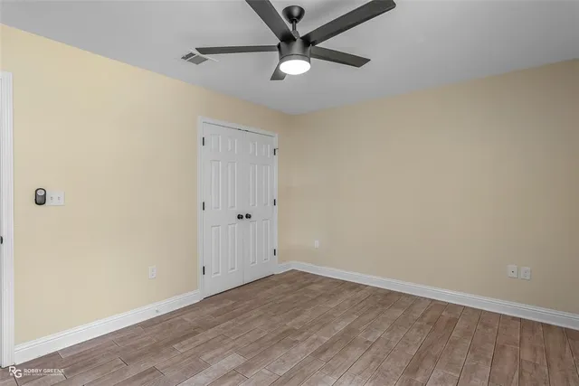 a view of an empty room with wooden floor
