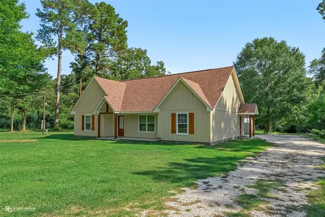 a front view of house with yard and green space