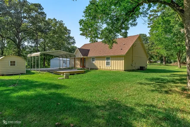 a front view of a house with yard and green space
