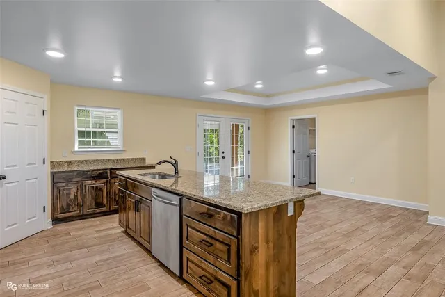 a kitchen that has a sink and a stove in it