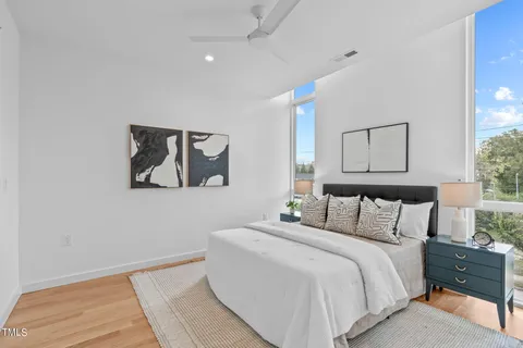 a bedroom with a bed and a lamp