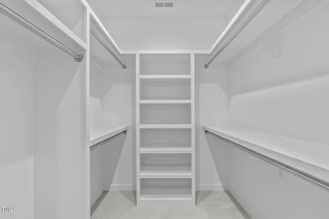 a spacious bathroom with a double vanity sink and a mirror