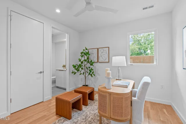 a bathroom with a granite countertop sink a toilet and a mirror