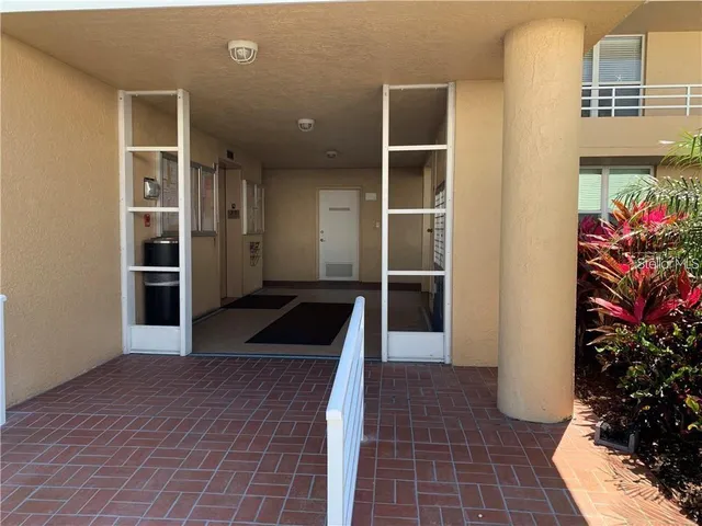 an empty room with wooden floor and plants