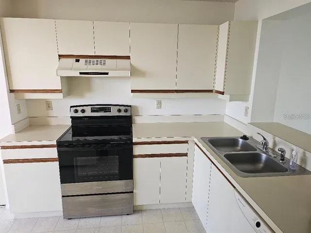 a kitchen with cabinets appliances and a sink