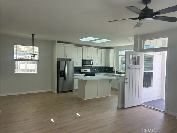 a kitchen with stainless steel appliances granite countertop a refrigerator and a stove top oven