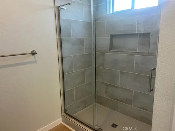 a bathroom with a glass shower door