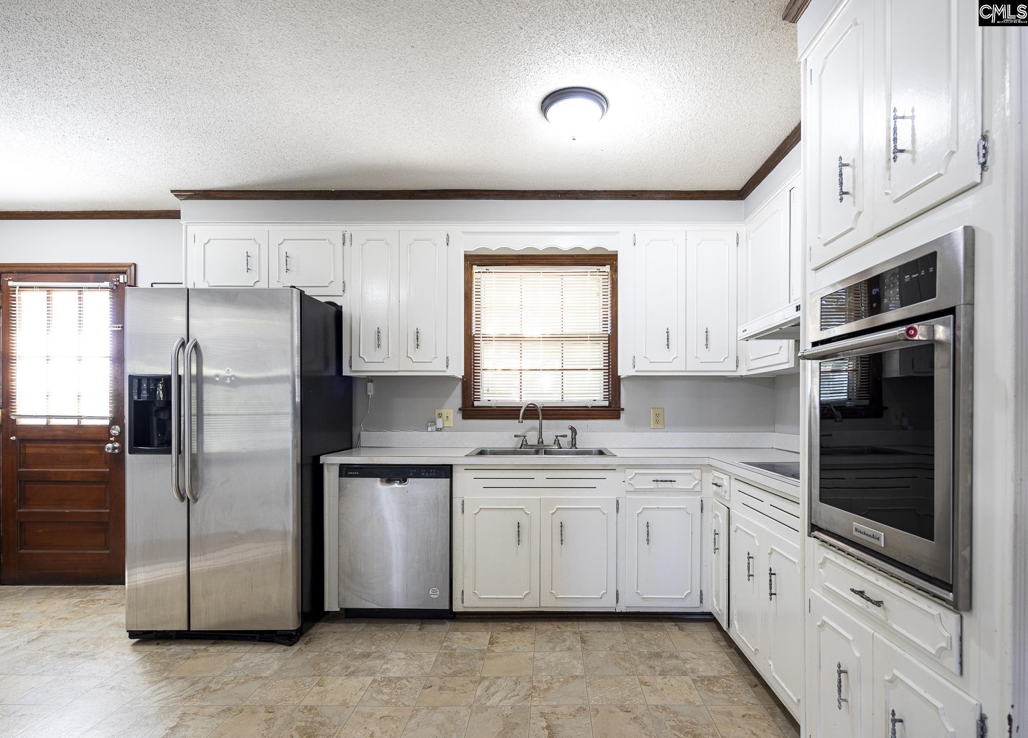 4083 Platt Springs Road West Columbia, SC 29170 - Photo 9 of 35 a kitchen with stainless steel appliances a refrigerator sink and microwave