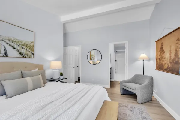 a bedroom with a bed and a couch