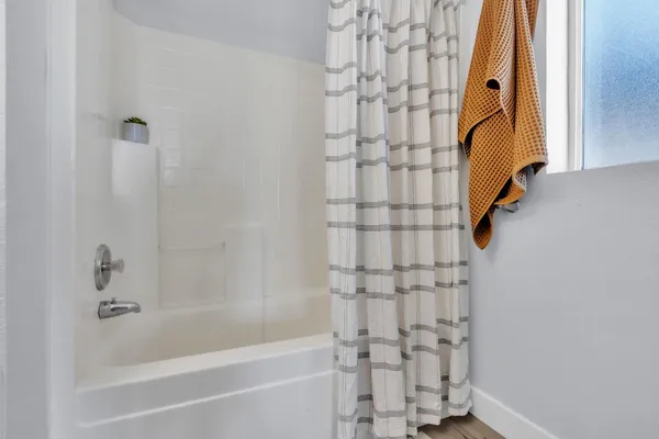 a bathroom with a bathtub and shower