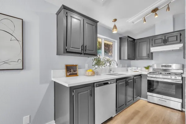 a kitchen with a sink and cabinets