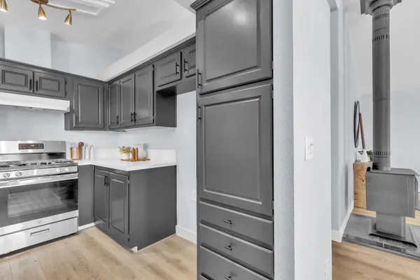 a kitchen with stainless steel appliances granite countertop a refrigerator and a stove