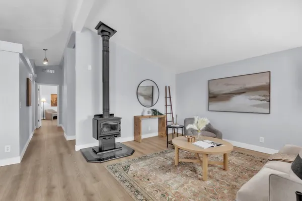 a living room with furniture a rug and a table