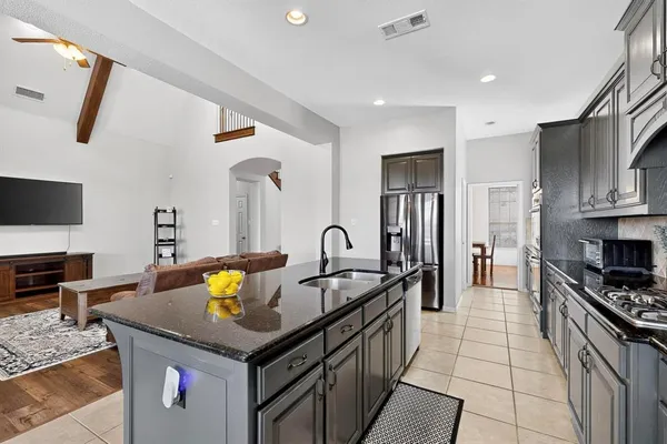 a kitchen with stainless steel appliances granite countertop a stove and a sink