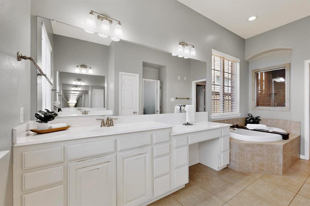 1240 Wedgewood Drive Forney, TX 75126 - Photo 21 of 40 a bathroom with double vanity sinks a mirror a vanity and a bathtub