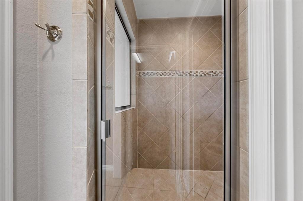 1240 Wedgewood Drive Forney, TX 75126 - Photo 22 of 40 a bathroom with a glass shower door