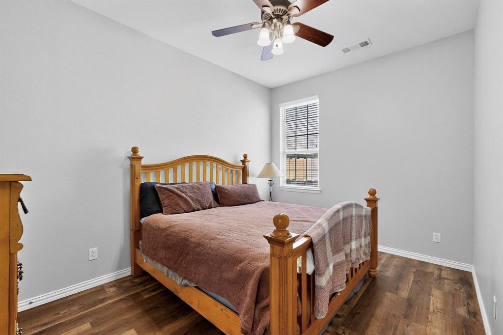 1240 Wedgewood Drive Forney, TX 75126 - Photo 25 of 40 a bedroom with a bed and wooden floor