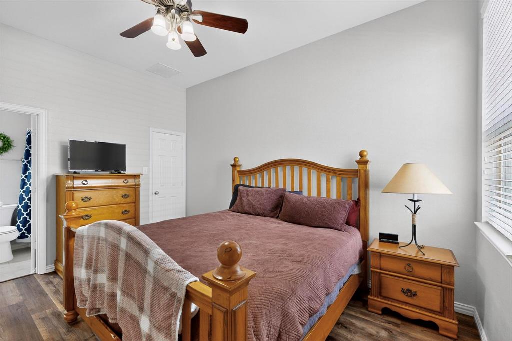 1240 Wedgewood Drive Forney, TX 75126 - Photo 26 of 40 a bedroom with a bed and wooden floor
