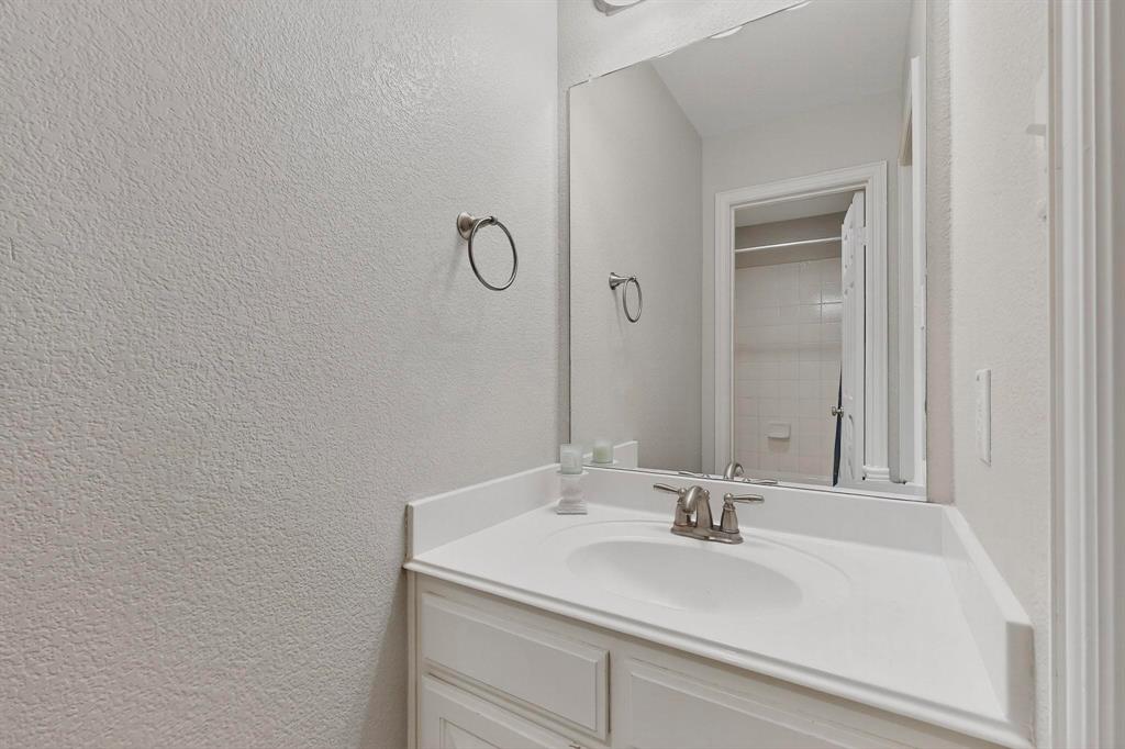 1240 Wedgewood Drive Forney, TX 75126 - Photo 31 of 40 a bathroom with a sink and a mirror