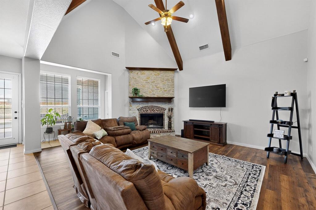 1240 Wedgewood Drive Forney, TX 75126 - Photo 9 of 40 a living room with furniture a flat screen tv and a fireplace