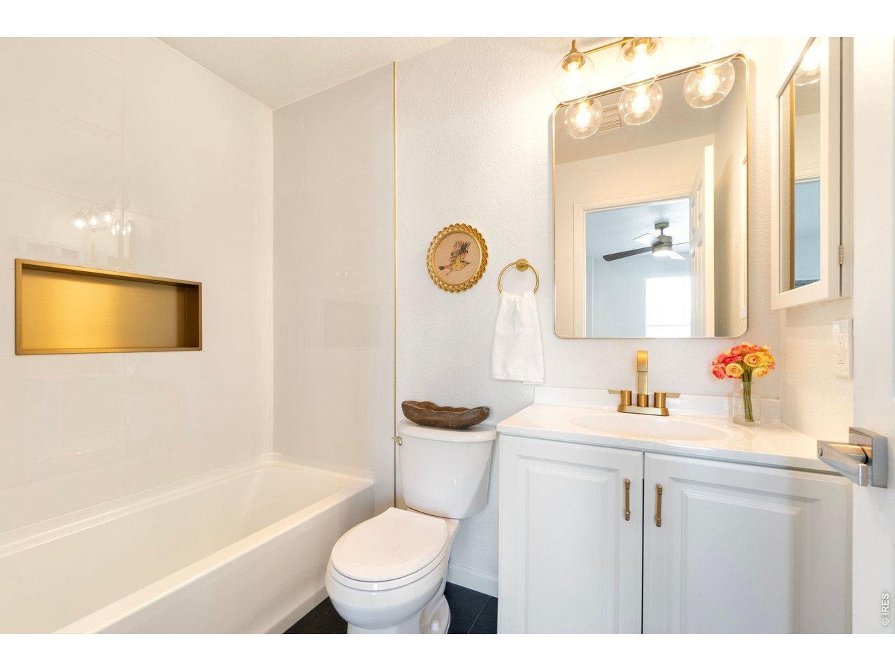5761 Ceylon Street Denver, CO 80249 - Photo 15 of 29 Clean, modern bathroom with stylish gold accents and fresh finishes.
