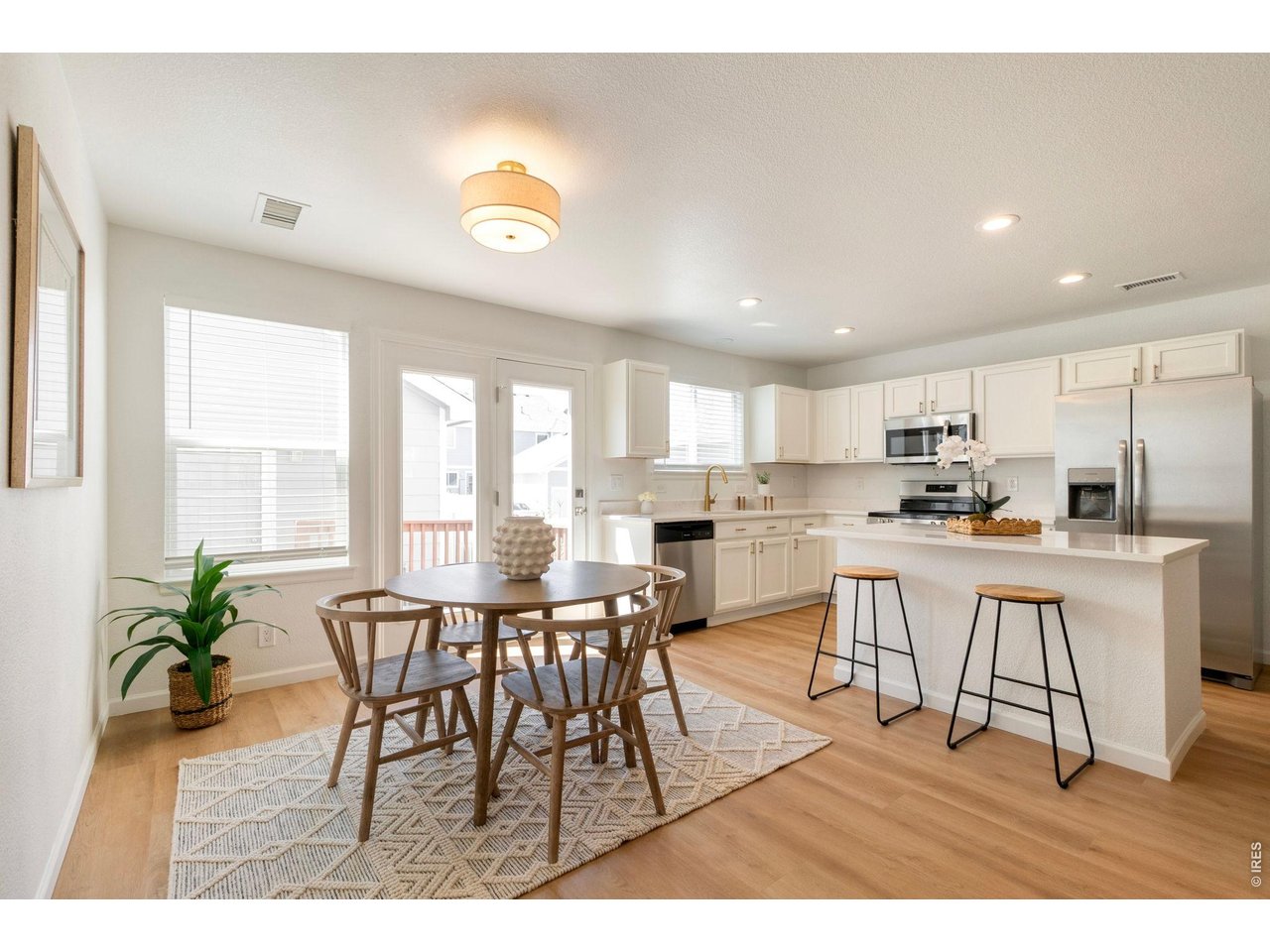 5761 Ceylon Street Denver, CO 80249 - Photo 6 of 29 Sun-filled dining area flowing seamlessly into the heart of the home.