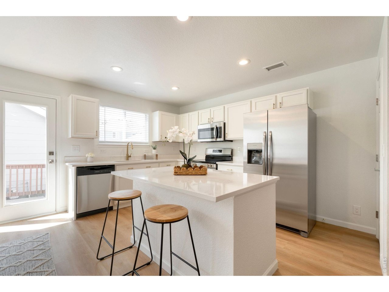 5761 Ceylon Street Denver, CO 80249 - Photo 9 of 29 Kitchen provides access to the back deck and yard space.
