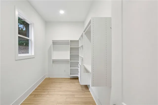 a view of a hallway with wooden floor and entryway