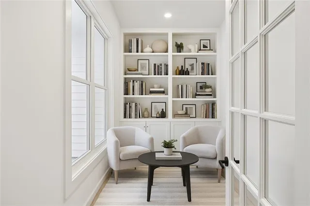 a living room with furniture and a book shelf