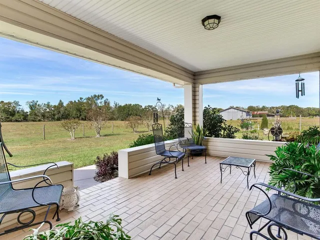 a front view of house with yard and trees in the background