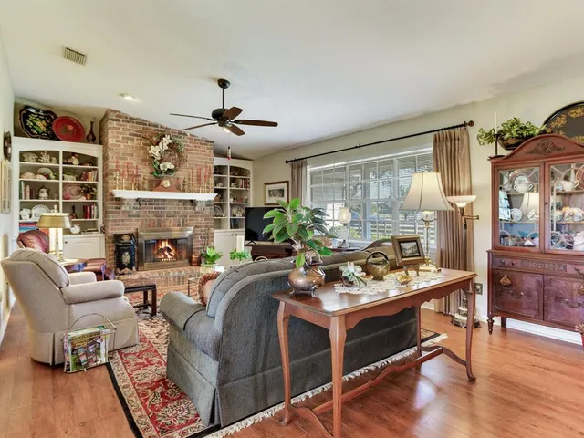 a kitchen with stainless steel appliances kitchen island granite countertop a sink a stove and a refrigerator