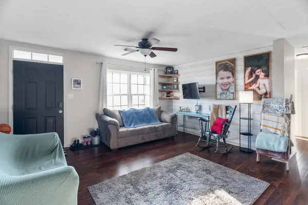 a living room with furniture and wooden floor