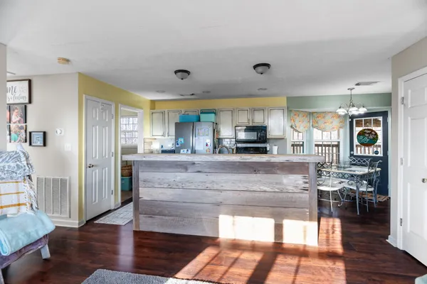a view of kitchen with stainless steel appliances granite countertop a stove and a refrigerator