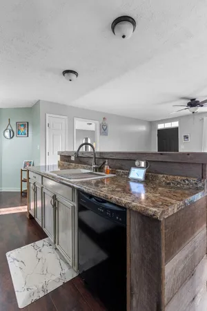 a kitchen with stainless steel appliances granite countertop a sink and stove