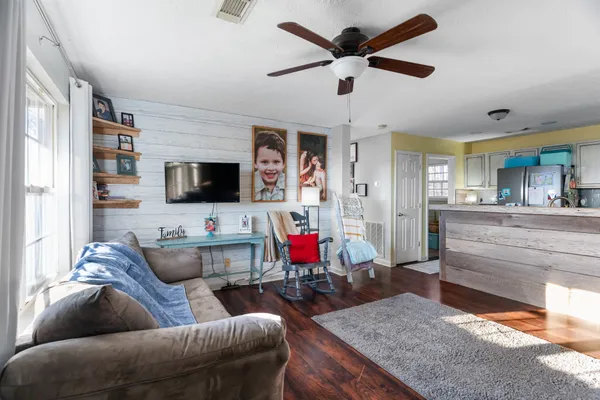 a living room with furniture and a flat screen tv