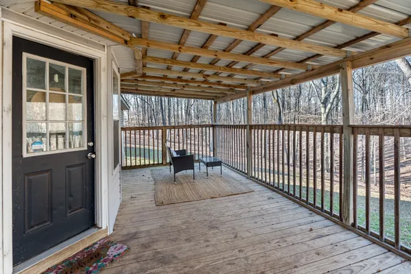 a view of a porch with wooden floor