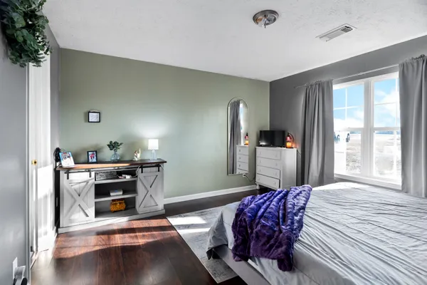 a bedroom with furniture and window