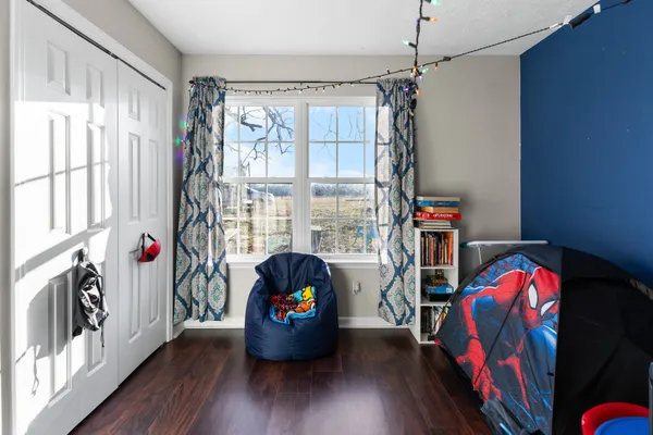 a view of a livingroom with entryway and wooden floor