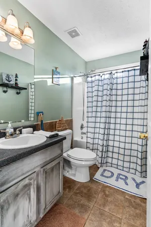 a bathroom with a double vanity sink toilet and mirror