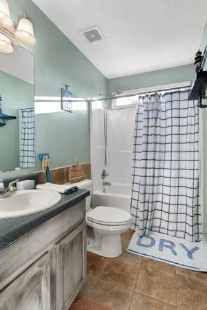 a bathroom with a double vanity sink toilet and shower