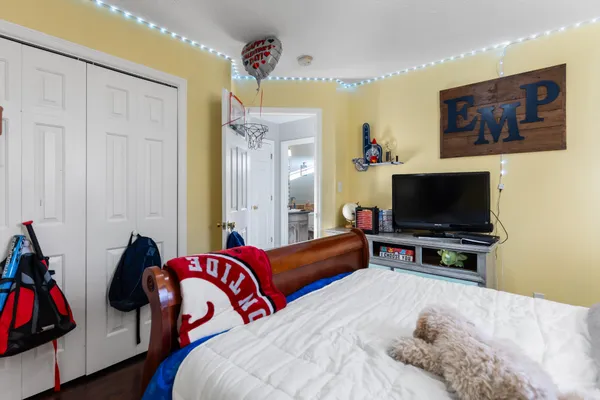 a bedroom with a bed and a flat screen tv