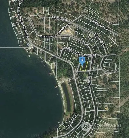 a view of a lake with houses in the back